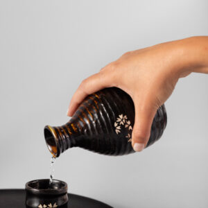 hand-pouring-drink-cup-high-angle